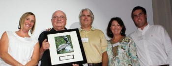 From left to right: Presenting the Award, federation's Sarah Phillips, and Vice President Dick Bierly; Accepting the Award: Walt, Paula and Ryan Roberson.