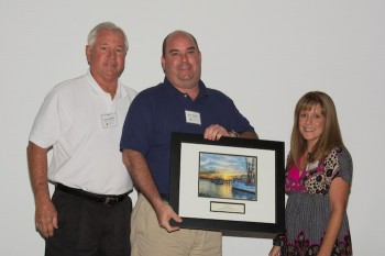 Jayson, left, and Wayne Barber accept the award from federation's coastal scientist Dr. Lexia Weaver.