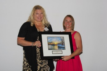 Dana Edgren accepting the award from federation's education coordinator Sarah Phillips, right.