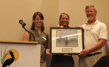 Bill Edwards, accepting the award from federation's coastal scientist Erin Fleckenstein, left, and federation's vice president Lauren Hermley.