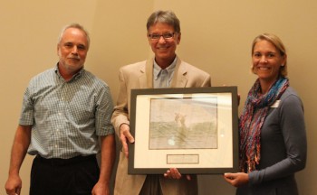 Jimmy Williams, center, accepting the award from federation's executive director Todd Miller and vice president Lauren Hermley.