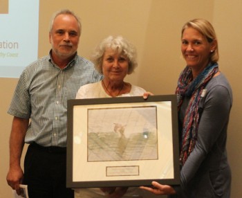 Sue Weddle, center, accepting the award from federation's executive director Todd Miller and vice president Lauren Hermley.
