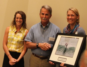 Troy Outland, accepting the award from federation's coastal advocate Ladd Bayliss, left and federation's vice president Lauren Hermley.