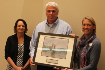 Tony Wilson accepting the award from federation's coastal scientist Tracy Skrabal, left, and federation's vice president Lauren Hermley.
