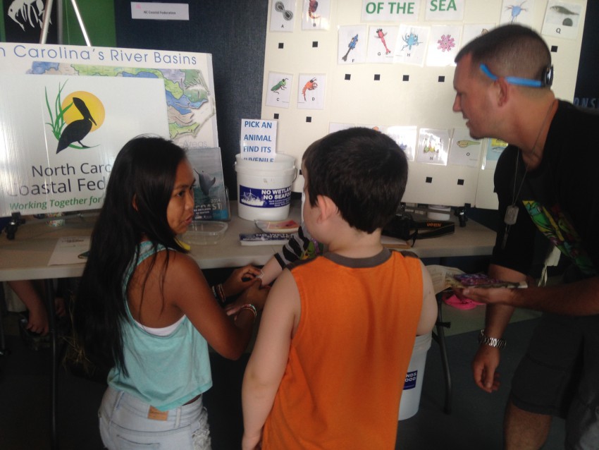 Visitors learn about the importance of estuaries at the federation's Earth Fair Booth
