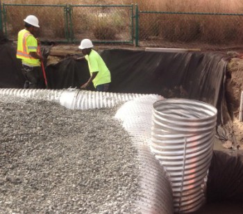 Workers with Coastal Stormwater Services install an innovative infiltration system to divert polluted stormwater runoff away from an outfall pipe leading into Banks Channel along Waynick Drive in Wrightsville Beach. Photo: N.C. Coastal Federation