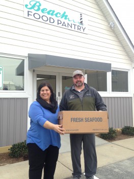 Theresa Armendarez, Beach Food Pantry, accepting fresh tilefish fillets donated from local commercial fishermen, including Dewey Hemilright.