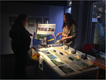 Coastal Fellow, Kristen Daly, describes the lesson to an educator at the local SciREN event in Pine Knoll Shores.