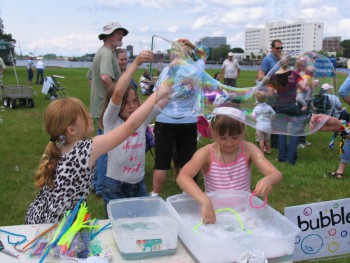 Children blow bubbles at the Titan-Free Jamboree Sunday in Wilmington.