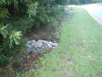 Check dams were installed along the entrance road to the Cedar Point recreation area to slow down water in the existing swale and aid in infiltration. The check dams are made from rock.