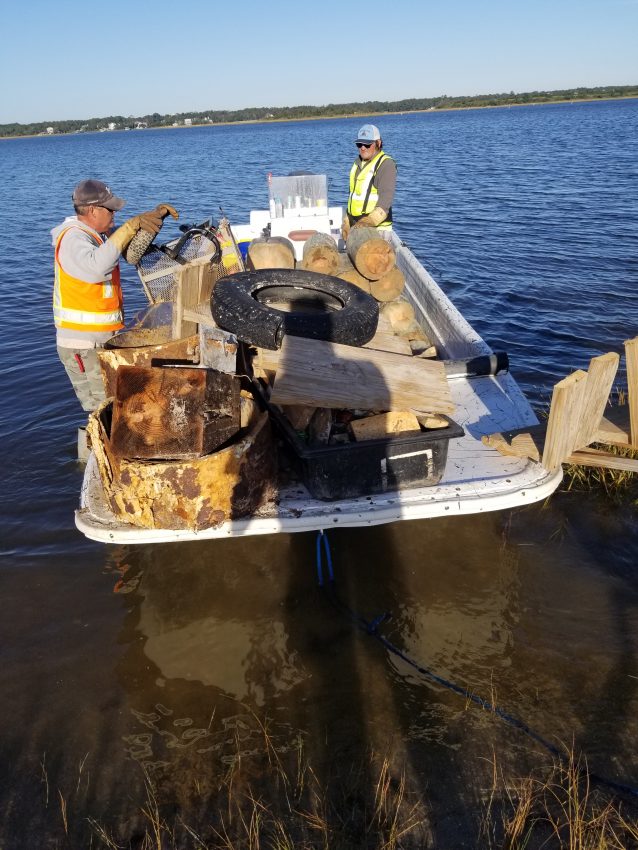 Marine Debris Removal crew members Mike Willis and Joey Huey with debris from Masonboro.