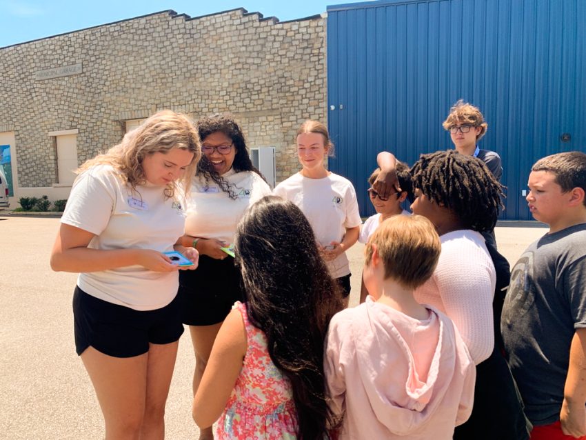 Interns Makayla and Audrey help students with a rain garden budget activity