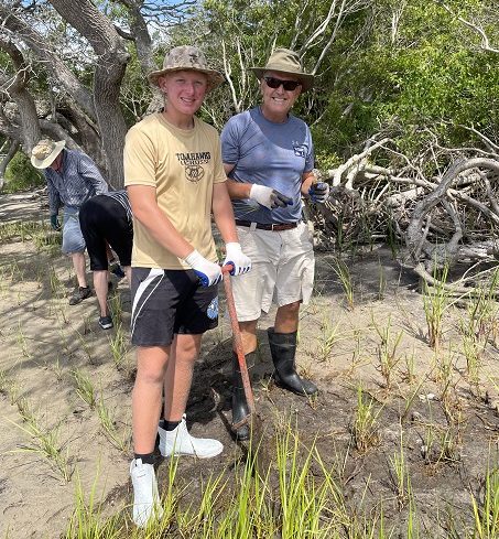 Volunteers plant native plants in the living shoreline at the Center.