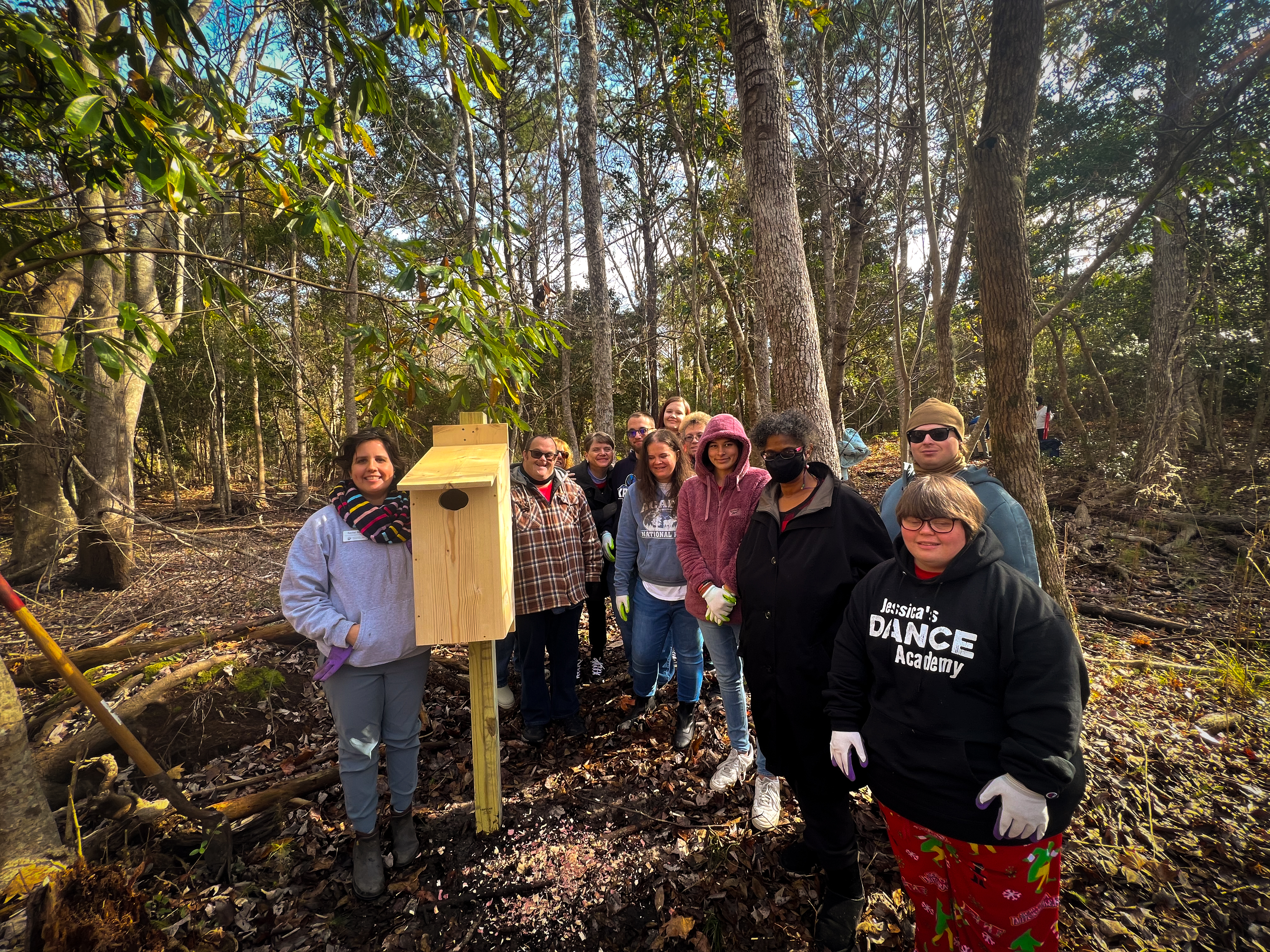 A group of students from Carteret Community College pose with the newly installed wood duck nesting box.
